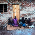 Katerine and family in front of their new house